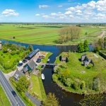 Aerial panorama from Fort Kijkuit and a medieval windmill at the river Vecht in the countryside from the Netherlands