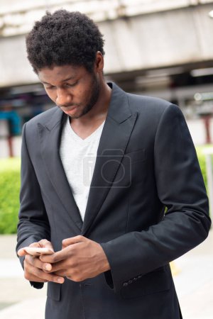 Photo for African business man using smartphone mobile application - Royalty Free Image