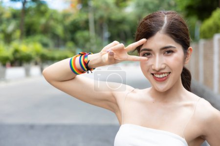 Photo for Non-binary LGBT person showing winning V for Victory hand sign for LGBT awareness pride month - Royalty Free Image