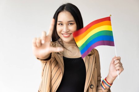 Photo for Non-binary LGBT person showing L hand sign for LGBT awareness pride month - Royalty Free Image