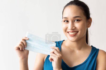 Photo for Woman happily taking off face mask, no more need to wear mask concept - Royalty Free Image