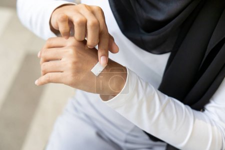 Photo for Wounded hand of woman, first aid treatment covering with clean bandage, closeup shot - Royalty Free Image
