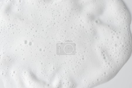 Foto de Fondo abstracto textura de espuma jabonosa blanca. Espuma de champú con burbujas - Imagen libre de derechos
