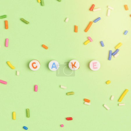 Photo for CAKE beads text typography on green - Royalty Free Image