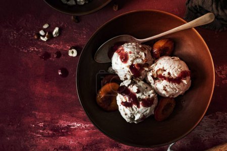 Photo for Roasted plums ice cream with chopped hazelnut - Royalty Free Image