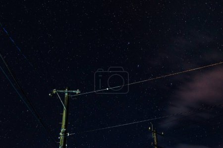 Photo for Electric post under starry sky. - Royalty Free Image