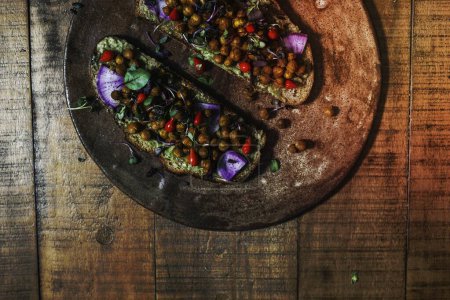 Foto de Homemade organic chickpea toast on a wooden plate - Imagen libre de derechos