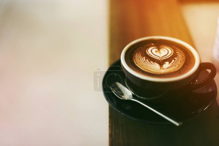 Photo for Coffee foam froth art on wooden table - Royalty Free Image