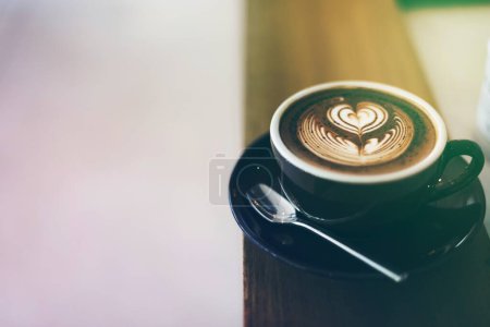 Photo for Coffee foam froth art on wooden table - Royalty Free Image