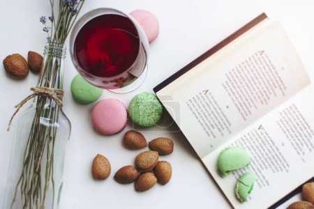 Photo for Pink and green macaroons and a book on the table - Royalty Free Image