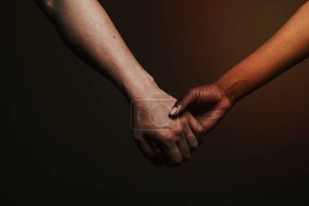 Photo for Black hand holding the white hand - Royalty Free Image