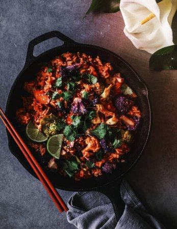 Photo for Kimchi fried rice with cilantro, sesame seeds, black pepper, and lime juice - Royalty Free Image