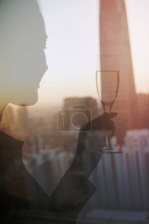 Photo for Double exposure of woman toasting with champagne flute over cityscape - Royalty Free Image