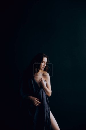 Beautiful, natural naked girl artistic posing at a stylish and fashionable nude photo shoot as a model in a photo studio with a transparent cape and bandage and looks like art Stickers 635944194