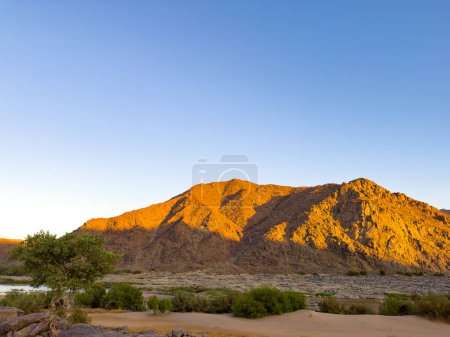 Photo for Sunrise at Tatasberg Camp Site on the Orange River in the Richtersveld National Park, arid area of South Africa - Royalty Free Image