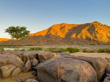Sunrise at Tatasberg Camp Site on the Orange River in the Richtersveld National Park, arid area of South Africa