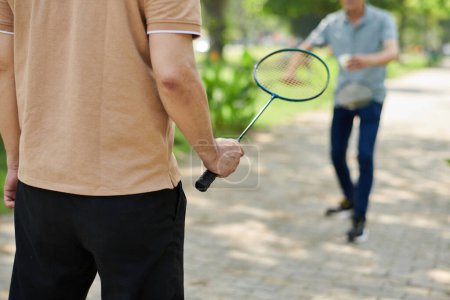 Photo for Cropped image of senior man playing badminton with his adult son - Royalty Free Image