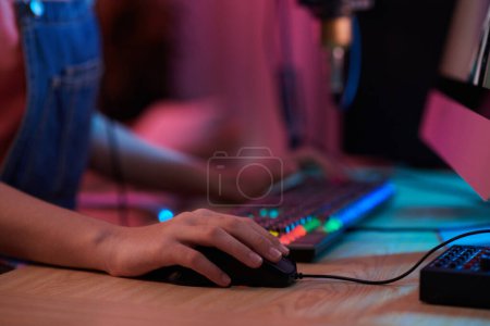 Foto de Closeup image of teenage girl playing strategy game on computer late at night - Imagen libre de derechos