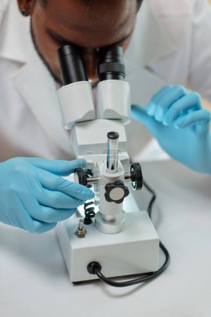 Photo for Researcher working with microscope in medical office - Royalty Free Image