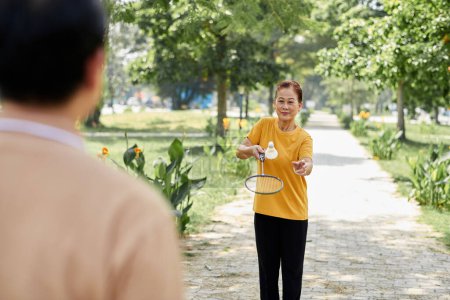 Photo for Senior woman playing badminton with her husband - Royalty Free Image