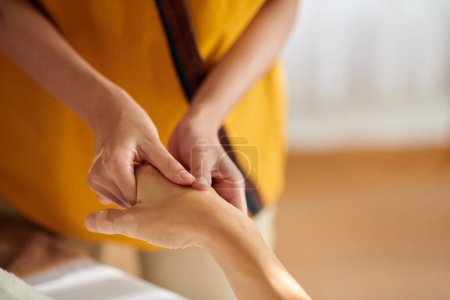 Photo for Masseuse giving relaxing healing and therapeutic hand massage to woman - Royalty Free Image