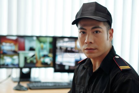 Foto de Portrait of security guard in uniform standing in office - Imagen libre de derechos