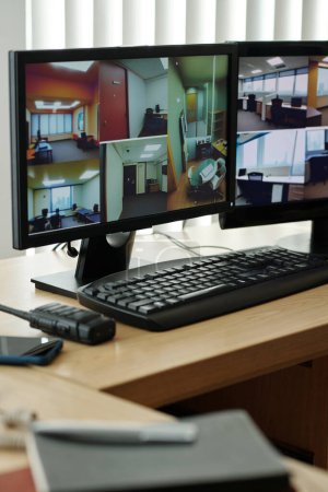 Foto de Monitors with footage from security cameras installed in company or bank office - Imagen libre de derechos