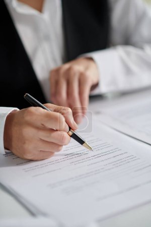Photo for Closeup image of social worker signing document - Royalty Free Image