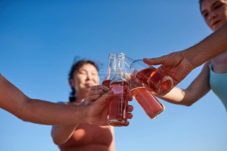 Photo for Close-up image of young people toasting with refreshing drinks at party - Royalty Free Image
