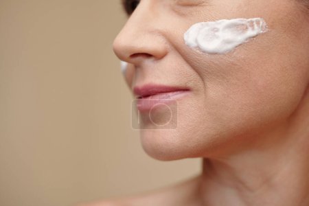 Photo for Nourishing cream on face of mature woman - Royalty Free Image