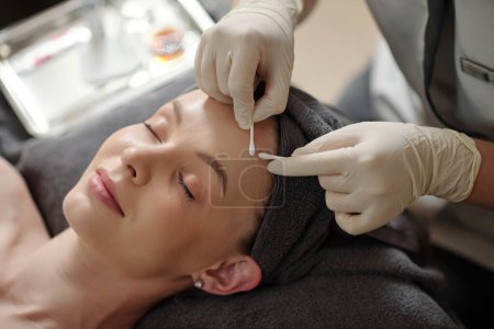 Photo for Young woman getting acne treatment procedure in spa salon - Royalty Free Image