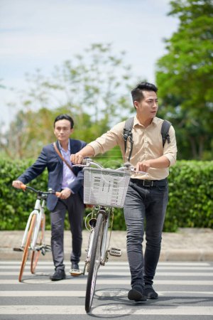 Photo for Business people with bicycles crossing road when hurrying to office - Royalty Free Image
