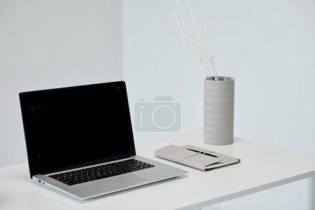 Photo for Laptop with empty screen and planner on office table - Royalty Free Image