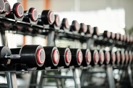 Photo for Rack with various dumbbells in gym, selective focus - Royalty Free Image