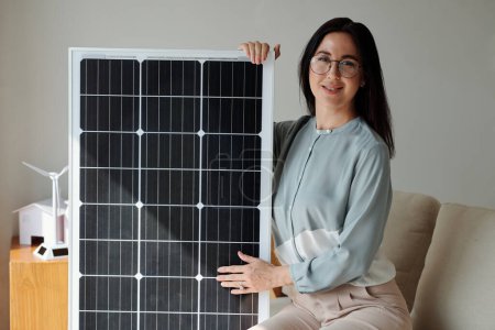 Photo for Portrait of smiling woman showing new model of solar panel - Royalty Free Image
