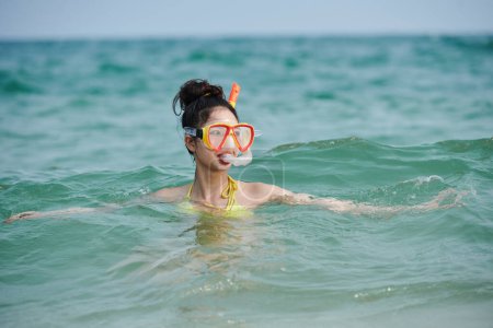 Photo for Young woman scuba diving in sea, summer vacation concept - Royalty Free Image