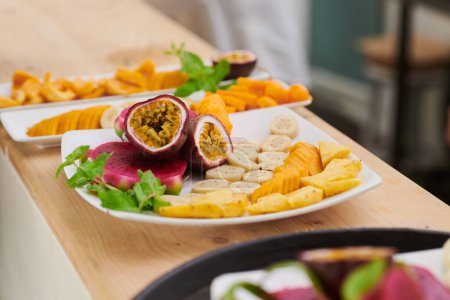 Photo for Delicious exotic fruits on plate ready to be served - Royalty Free Image