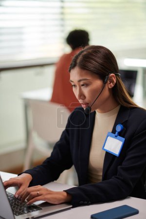 Photo for Technical support operator answering questions of clients when working in office - Royalty Free Image