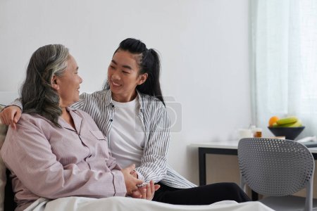 Photo for Cheerful senior woman talking to adult daughter visiting her on weekend - Royalty Free Image
