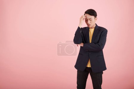 Photo for Stressed young businessman thinking how to solve problem, isolated on pink - Royalty Free Image