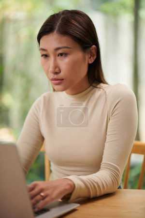 Photo for Portrait of serious young businesswoman working her own project - Royalty Free Image
