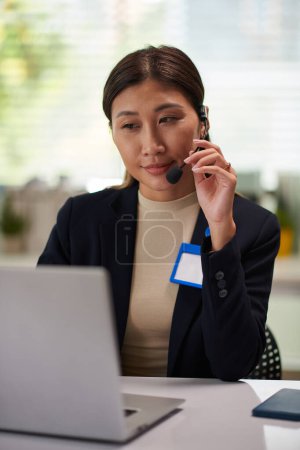Photo for Portrait of smiling qa engineer answering phone call from client - Royalty Free Image
