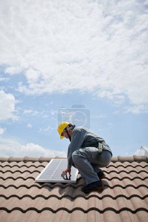 Photo for Solar contractor installing panels on roof, renewable energy concept - Royalty Free Image