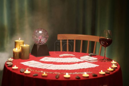 Photo for Table of future teller with crystal ball, burning candles and tart cards - Royalty Free Image