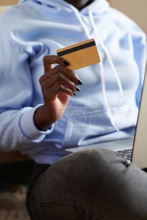 Photo for Close-up image of young woman making purchases online and paying with credit card - Royalty Free Image