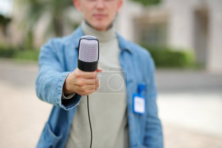 Téléchargez les photos : Journaliste tendre la main avec microphone et poser des questions - en image libre de droit