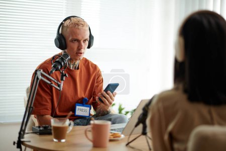 Photo for Press representative talking to guest at radio show - Royalty Free Image