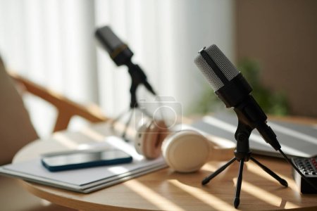 Photo for Microphones on table prepared for podcaster and show guest - Royalty Free Image