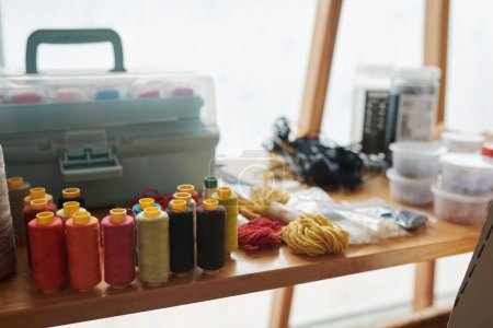 Photo for Thread reels and yarn on desk of craftsperson - Royalty Free Image