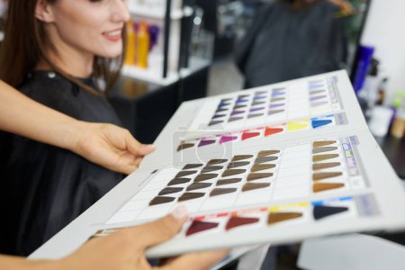 Photo for Close-up image of hairstylist giving customer hair color chart - Royalty Free Image